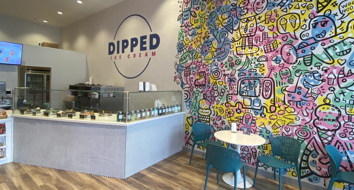 Inside the Dipped Ice Cream store in El Segundo, with the logo wall and doodle mural